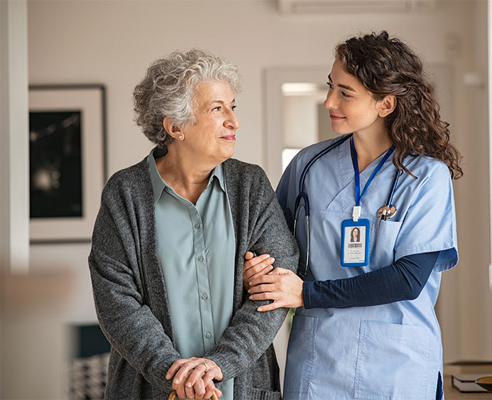 Nurse assisting her old woman patient