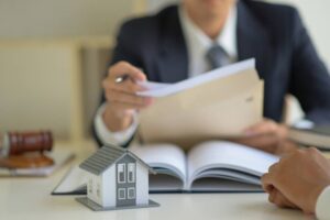 The lawyer is consulting clients about the house purchase contract.