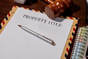 Property Title Document on Envelope with Pen and Gavel Represents Legal Ownership and Transfer Processes in Real Estate Law