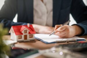 professional real estate agent signing important documents for a home purchase.